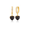 Gold hoop earrings with black heart-shaped charms