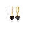 Gold hoop earrings with heart-shaped black gemstone drops 