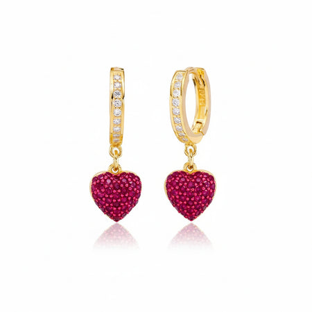 Gold hoop earrings with red heart-shaped charms 