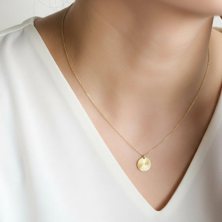 Gold necklace with a coin shining pedant